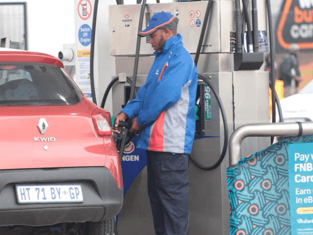 Fuel station worker putting petrol in Customer's car