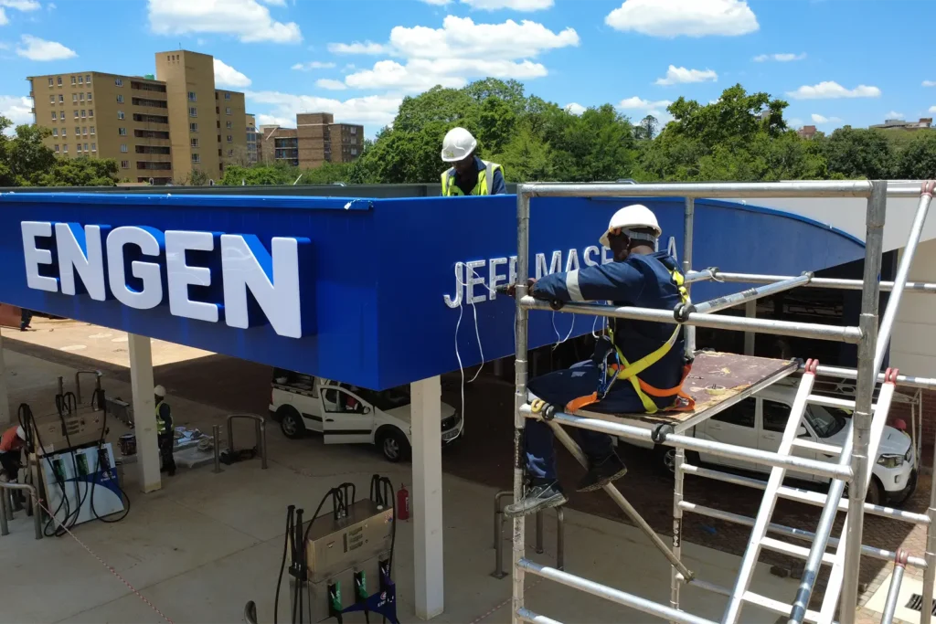 fuel station refurbishment - Engen signage being installed during the retail fuel station project Jeff Masemola