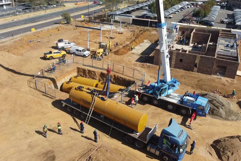 Retail fuel station project Carlswald underground fuel tanks being positioned during pump and tank construction