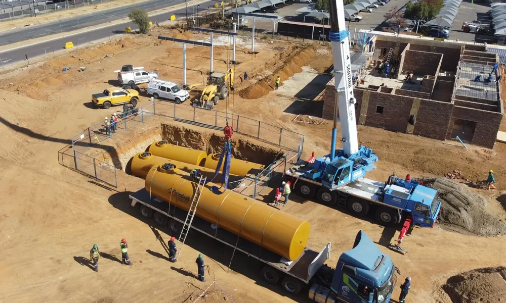 Retail fuel station project Carlswald underground fuel tanks being positioned during pump and tank construction