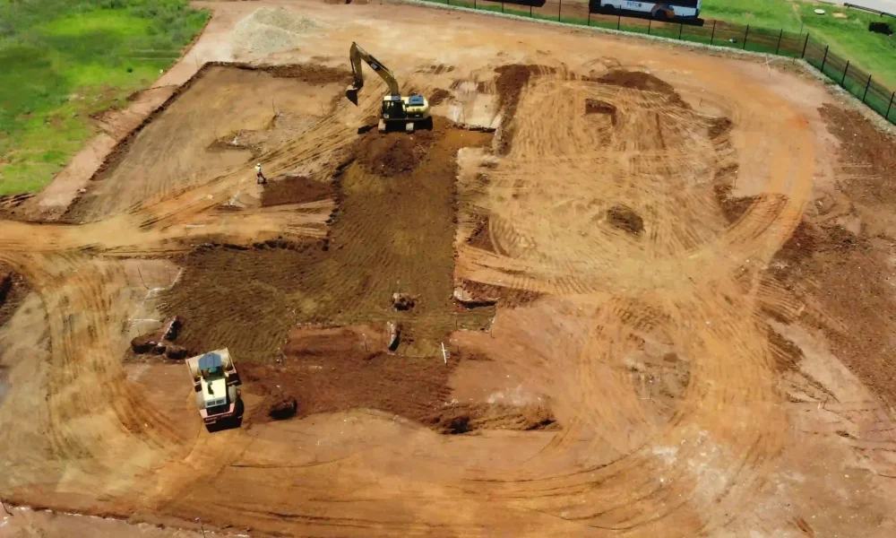 retail fuel station Kempton Park early ground works with excavator, compactor and prepared site platform