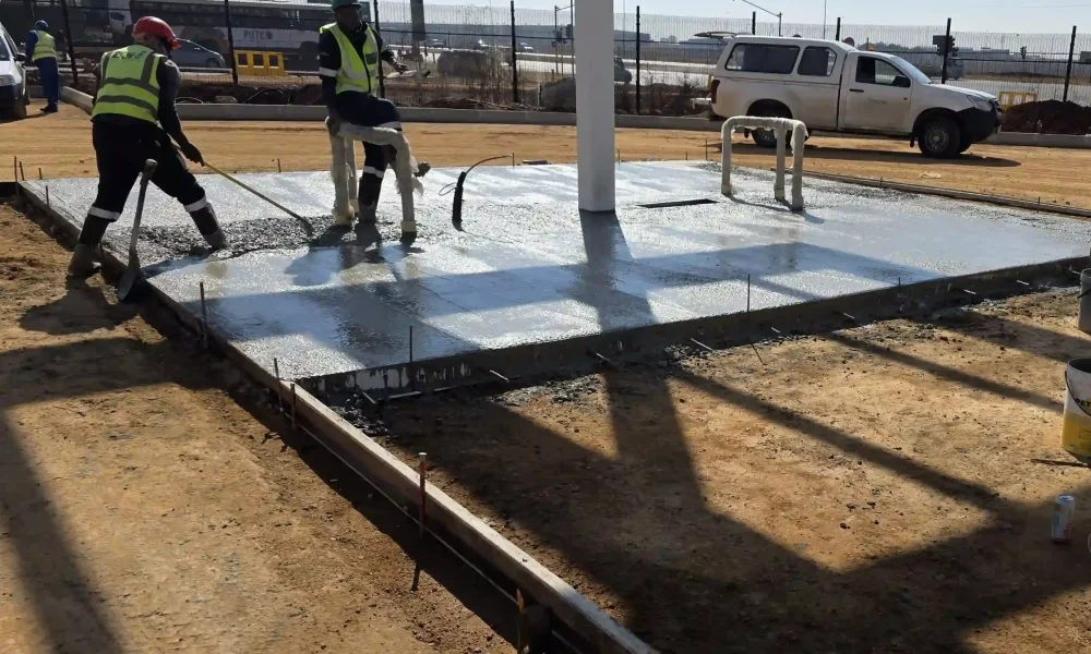 retail fuel station Kempton Park reinforced concrete pour with steel mesh, manholes and construction crew