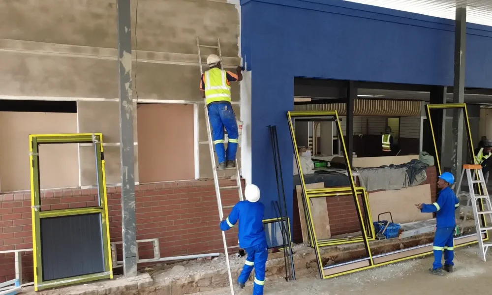Contractors installing the shopfront for the retail fuel station project Jeff Masemola