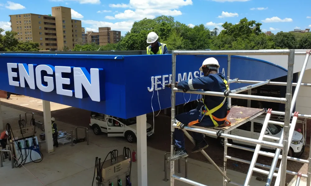 fuel station refurbishment - Engen signage being installed during the retail fuel station project Jeff Masemola